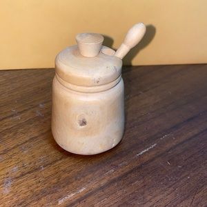 Solid wood honey jar with spoon and lid.